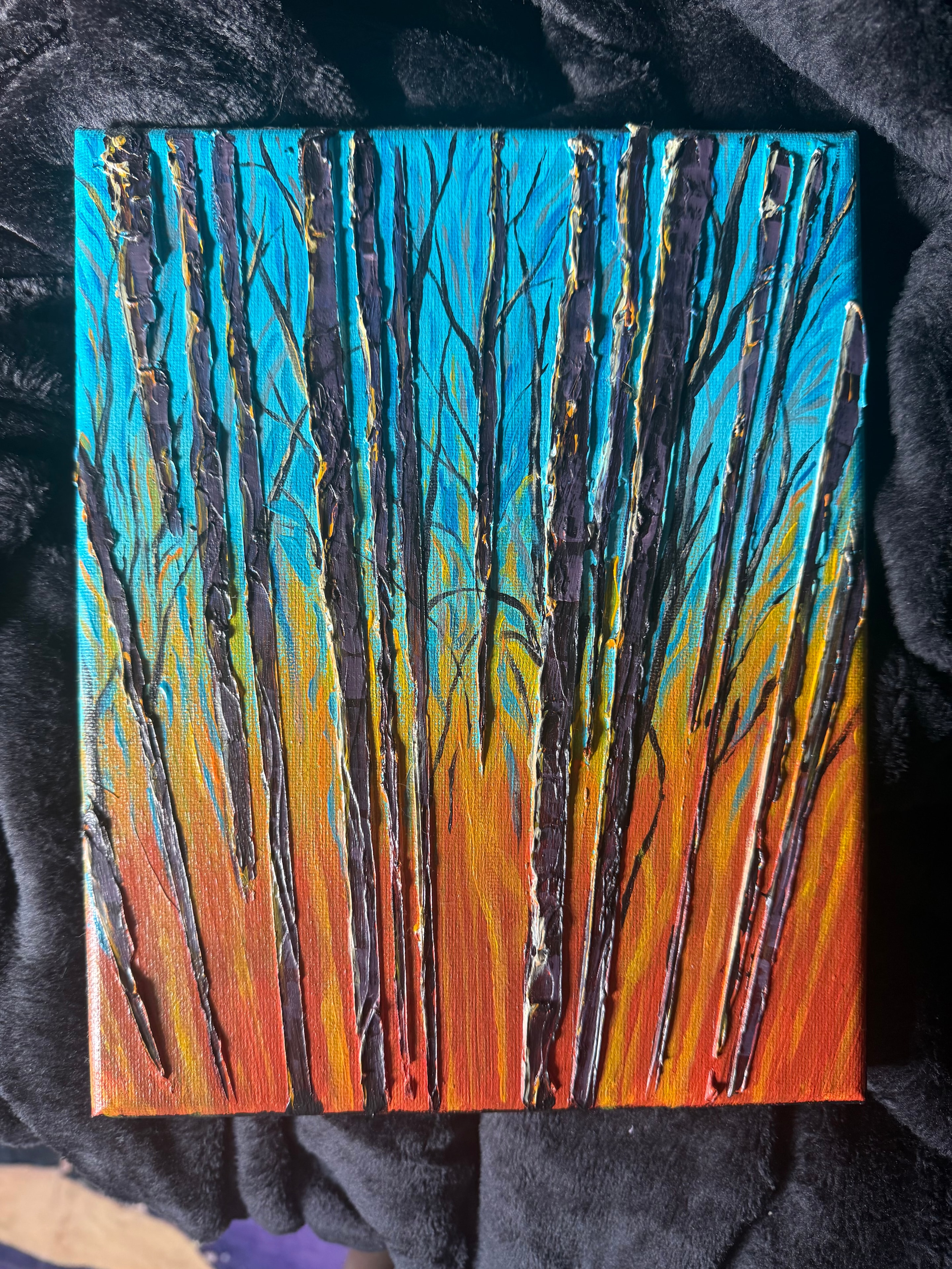Fire Sky Birch — original 8x10 inch caulk art painting by Jay the Painter, Akron Ohio. Tall dark birch trunks with gold leaf highlights rising through blazing gradient of turquoise gold orange and deep red, heavy 3D caulk texture technique.