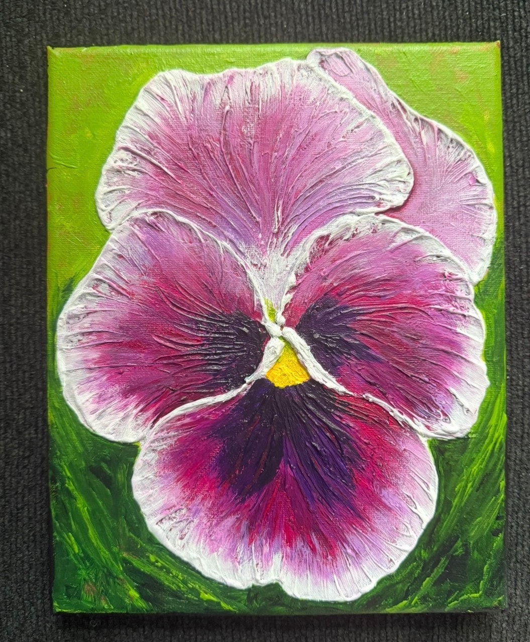 Violet Pansy in Full Bloom — original 8x10 inch caulk art painting by Jay the Painter, Akron Ohio. Massive violet and magenta pansy filling entire canvas with thick radiating caulk ridges, deep purple-black center with yellow stamen, dark green swirling background, heavy 3D caulk texture technique.